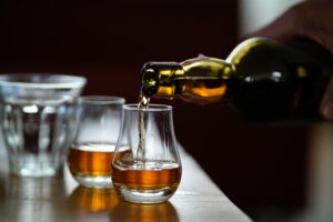 Whiskey being poured into glasses.